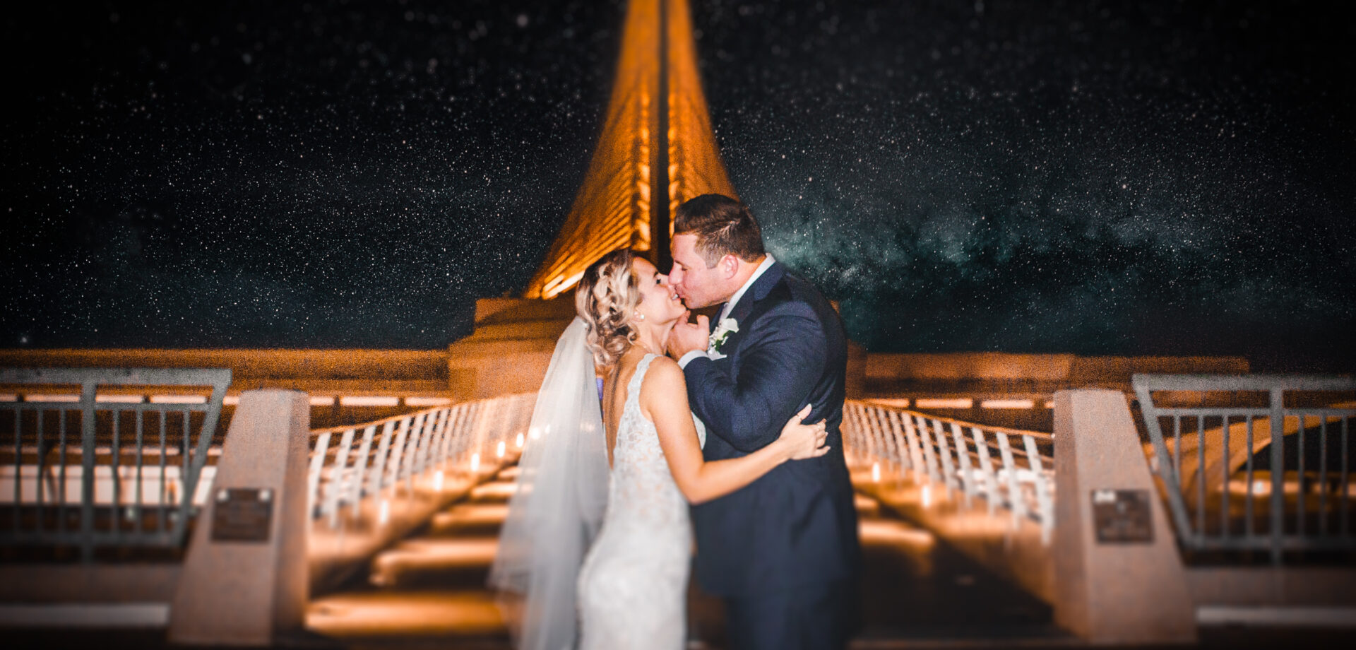 Couple kissing on the pier at Coast Event & Wedding Venue